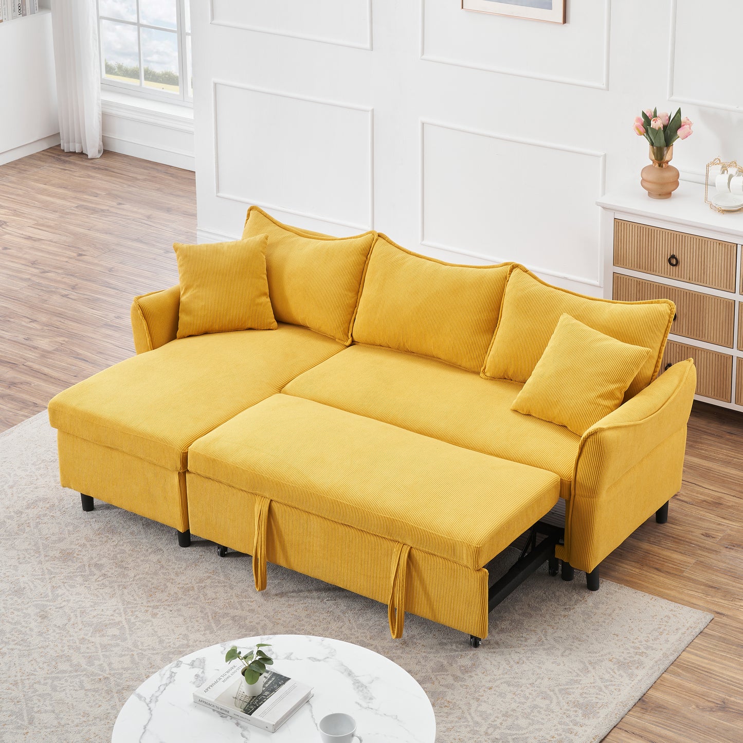 The 80-inch yellow corduroy L-shaped sofa comes with two small throw pillows that can be converted into a sofa bed for storage