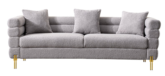Luxurious and comfortable upholstered sofa with golden legs and pillows for living room and reception area