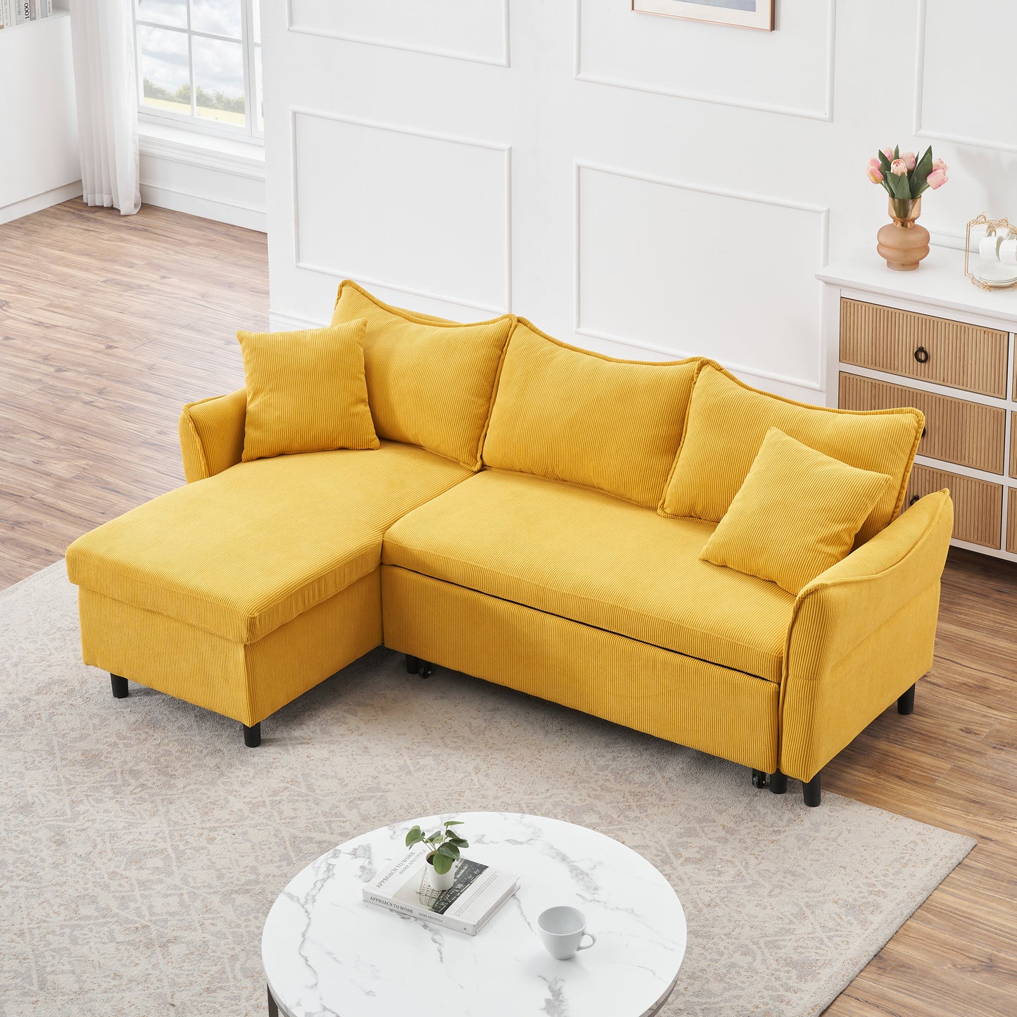 The 80-inch yellow corduroy L-shaped sofa comes with two small throw pillows that can be converted into a sofa bed for storage